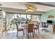 Sunlit dining room with pond view and coastal decor at 3810 75Th W St # 128, Bradenton, FL 34209