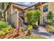 Charming condo with lush landscaping, wooden stairs, and vibrant hibiscus tree at entrance at 3810 75Th W St # 128, Bradenton, FL 34209