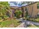 Exterior view features lush landscaping, wooden stairs, and a 'Paradise Ct' sign at 3810 75Th W St # 128, Bradenton, FL 34209
