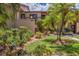Charming exterior view of the condo with lush landscaping and walkway, showcasing curb appeal at 3810 75Th W St # 128, Bradenton, FL 34209