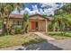 Charming single-story home with a pathway leading to the vibrant orange front door at 3810 75Th W St # 128, Bradenton, FL 34209