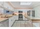 Bright kitchen featuring white cabinets, stainless steel appliances, and ample counter space at 3810 75Th W St # 128, Bradenton, FL 34209