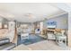 Open living area featuring stylish decor, tile floors, and a pass-through to the kitchen at 3810 75Th W St # 128, Bradenton, FL 34209
