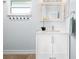 Bathroom with white vanity, decorative mirror, and window for natural light at 3915 Meadow Creek Dr, Sarasota, FL 34233