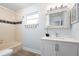 Bathroom featuring a tub, a window, white vanity, and decorative mirror at 3915 Meadow Creek Dr, Sarasota, FL 34233