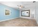 Bedroom featuring a ceiling fan, tile flooring, and a large mirror reflecting natural light at 3915 Meadow Creek Dr, Sarasota, FL 34233