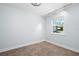 Bedroom featuring a large window, neutral colors, and tile flooring at 3915 Meadow Creek Dr, Sarasota, FL 34233