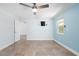 Bedroom featuring a ceiling fan, tile flooring, neutral colors, and two windows providing natural light at 3915 Meadow Creek Dr, Sarasota, FL 34233