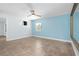 Spacious bedroom featuring a ceiling fan, tile flooring, and a bright, refreshing color scheme at 3915 Meadow Creek Dr, Sarasota, FL 34233