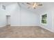 Vaulted ceiling bedroom with a ceiling fan, track lighting, tile flooring and natural light at 3915 Meadow Creek Dr, Sarasota, FL 34233