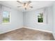 Bright bedroom featuring tile floors, windows, and a ceiling fan for comfort at 3915 Meadow Creek Dr, Sarasota, FL 34233