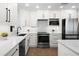 Well-lit kitchen with stainless steel appliances, quartz countertops, and modern cabinetry at 3915 Meadow Creek Dr, Sarasota, FL 34233