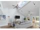 Bright living room with vaulted ceilings, tile floors, ceiling fans, and a sliding door to the backyard at 3915 Meadow Creek Dr, Sarasota, FL 34233