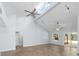 Bright living room with vaulted ceilings, tile floors, ceiling fans, and a sliding door to the backyard at 3915 Meadow Creek Dr, Sarasota, FL 34233