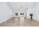 Open living room with tile floors, fan, and access to the outdoors through sliding glass doors at 3915 Meadow Creek Dr, Sarasota, FL 34233