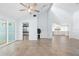 Bright living room featuring tile floors, ceiling fan, and sliding glass doors to outdoor space at 3915 Meadow Creek Dr, Sarasota, FL 34233