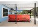 A covered outdoor bar area featuring an eye-catching orange bar with tropical-themed graphics at 3915 Meadow Creek Dr, Sarasota, FL 34233