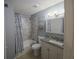 Bathroom with tiled tub-shower, single sink vanity, and decor at 4001 Beneva Rd # 319, Sarasota, FL 34233