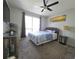 A cozy bedroom featuring a bed, dark furniture, coastal decor, and a ceiling fan at 4001 Beneva Rd # 319, Sarasota, FL 34233