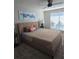 Inviting bedroom features a ceiling fan, large window, and a comfortable upholstered bed at 4001 Beneva Rd # 319, Sarasota, FL 34233