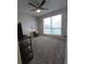 Cozy bedroom features neutral walls, soft carpet, a ceiling fan, and a bright window view at 4001 Beneva Rd # 319, Sarasota, FL 34233