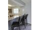A modern kitchen features a breakfast bar with granite countertops and seating for three at 4001 Beneva Rd # 319, Sarasota, FL 34233