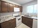 Spacious kitchen featuring updated appliances, granite countertops, and a classic backsplash at 4001 Beneva Rd # 319, Sarasota, FL 34233
