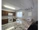 Well-lit kitchen featuring modern appliances, granite countertops, and wine glass rack at 4001 Beneva Rd # 319, Sarasota, FL 34233