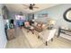 Cozy living room with comfortable seating, ceiling fan, and beach-themed decor at 4001 Beneva Rd # 319, Sarasota, FL 34233