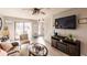 Comfortable living area with wood-look flooring, TV, fireplace, and plenty of natural light at 4001 Beneva Rd # 319, Sarasota, FL 34233