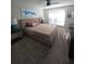 A bright main bedroom features a large bed, neutral decor, and plenty of natural light at 4001 Beneva Rd # 319, Sarasota, FL 34233