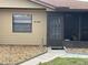 Tan home exterior featuring well-maintained landscaping and a clearly visible house number at 4199 66Th Street W Cir # 4199, Bradenton, FL 34209