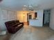 Spacious living room with a ceiling fan and adjacent breakfast bar provides easy flow to other areas at 4199 66Th Street W Cir # 4199, Bradenton, FL 34209