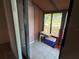 Enclosed porch featuring tile flooring, shelving, and backyard view from multiple windows at 4199 66Th Street W Cir # 4199, Bradenton, FL 34209