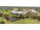 Scenic aerial view of the condo complex, landscaped grounds, pond, and golf course at 4440 Fairways Blvd # 310, Bradenton, FL 34209