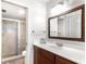Clean bathroom with shower and glass door, white countertop vanity with dark wood cabinets and a framed mirror at 4440 Fairways Blvd # 310, Bradenton, FL 34209