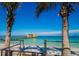 Stunning view of turquoise water and sandy beach from a beachfront property framed by palm trees under a blue sky at 4440 Fairways Blvd # 310, Bradenton, FL 34209