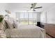 Bright bedroom featuring a tufted headboard, light wood floors and lots of natural light from the large window at 4440 Fairways Blvd # 310, Bradenton, FL 34209
