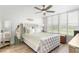 Bright bedroom featuring a tufted headboard, light wood floors and lots of natural light from the large window at 4440 Fairways Blvd # 310, Bradenton, FL 34209