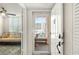 Entryway featuring view to outside balcony, tile floors, open door and an adjacent room with a comfortable couch at 4440 Fairways Blvd # 310, Bradenton, FL 34209