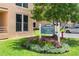 Manicured landscaping surrounds the community sign near the building with a peek at a vehicle in the lot at 4440 Fairways Blvd # 310, Bradenton, FL 34209
