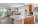 Bright kitchen featuring granite countertops, stainless sink and appliances, and open to a stylishly furnished living area at 4440 Fairways Blvd # 310, Bradenton, FL 34209