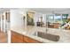 Bright kitchen featuring granite countertops and stainless sink with views of stylishly furnished living area at 4440 Fairways Blvd # 310, Bradenton, FL 34209