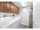 Laundry room with front loading washer and dryer, upper cabinets and wood look floors at 4440 Fairways Blvd # 310, Bradenton, FL 34209