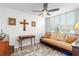 Sitting area with tan couch, lots of pillows, wood look floors, shutters and a dark wood end table at 4440 Fairways Blvd # 310, Bradenton, FL 34209