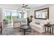 Bright living room with cozy furnishings, large mirror, and views of the green landscape at 4440 Fairways Blvd # 310, Bradenton, FL 34209