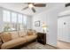 Sitting area with tan couch, lots of pillows, wood look floors, shutters and a dark wood end table at 4440 Fairways Blvd # 310, Bradenton, FL 34209