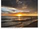 Breathtaking sunset over the ocean, casting a warm glow on the beach and waves, highlighting the natural beauty at 4440 Fairways Blvd # 310, Bradenton, FL 34209