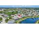 Beautiful aerial view of a property on the lake with a screen enclosed pool and well maintained landscaping at 4531 Useppa Dr, Bradenton, FL 34203
