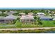 Aerial shot of the backyard featuring a screened-in pool and lush green lawn overlooking a lake at 4531 Useppa Dr, Bradenton, FL 34203